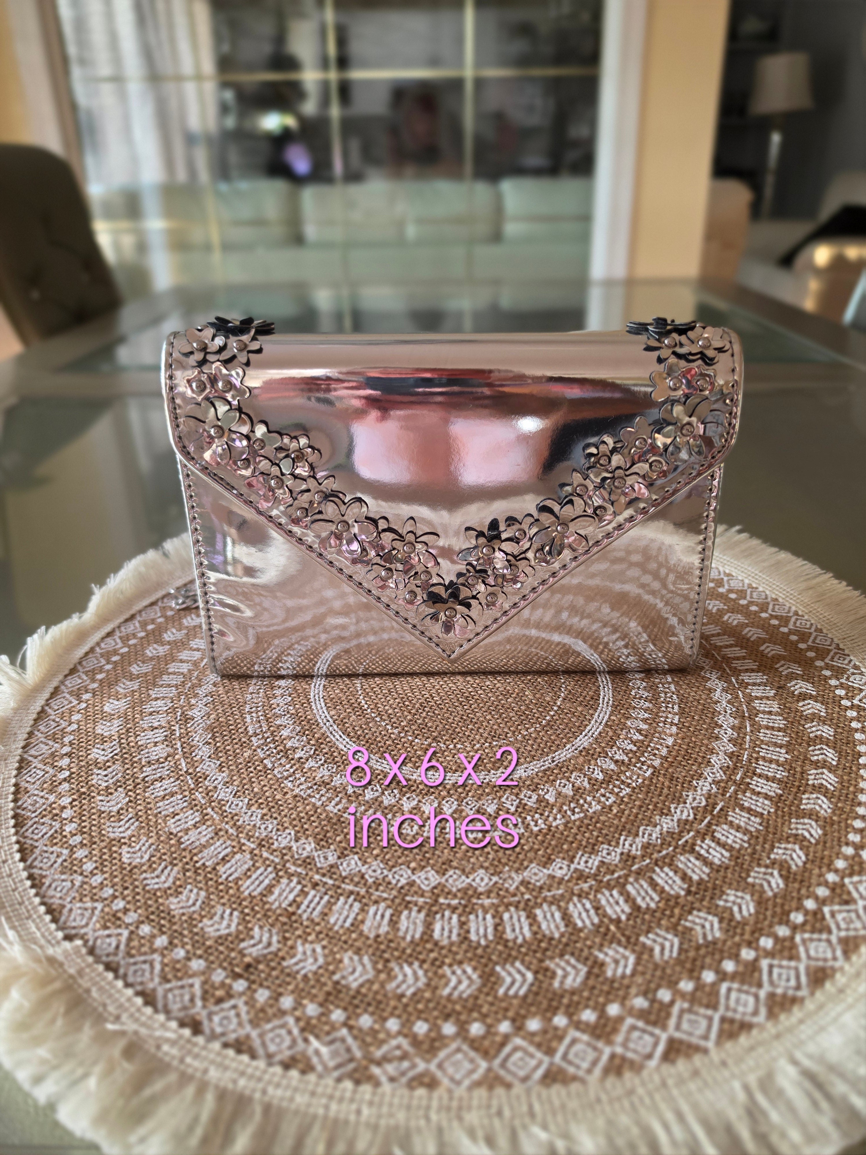 ALDO silver metallic clutch — front floral detail