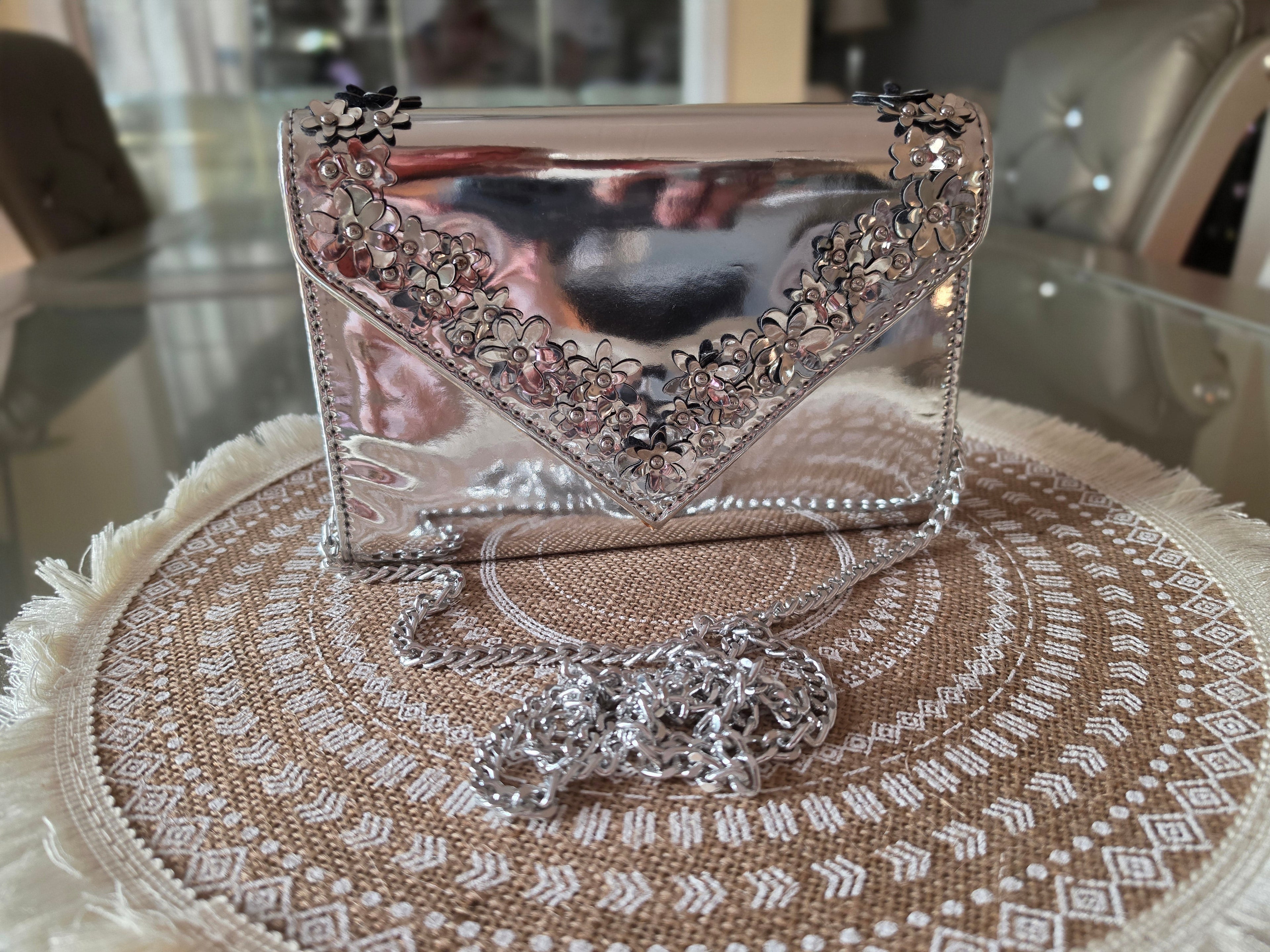 ALDO silver metallic clutch — front with chain strap