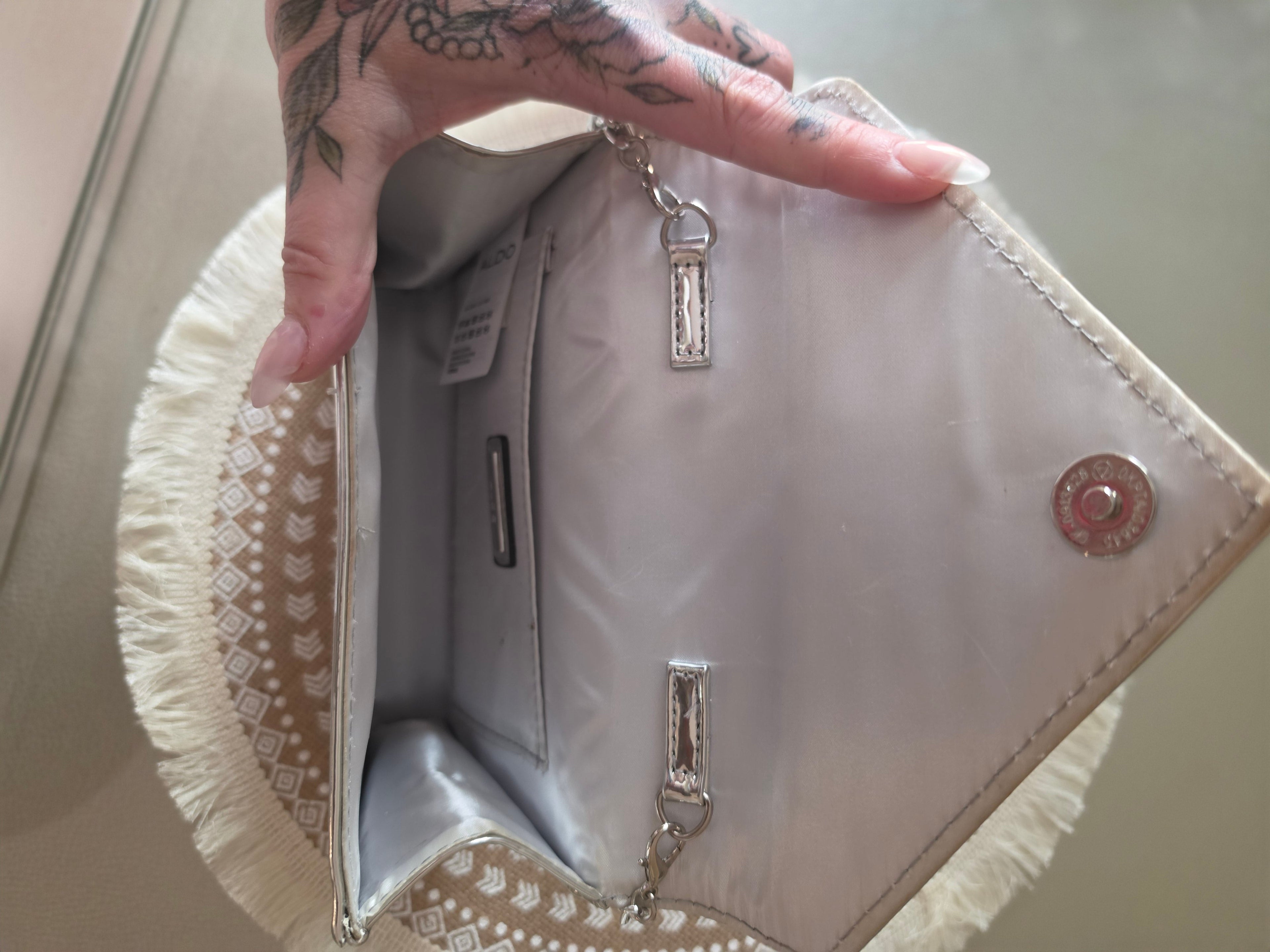 ALDO silver metallic clutch — interior lining and pockets