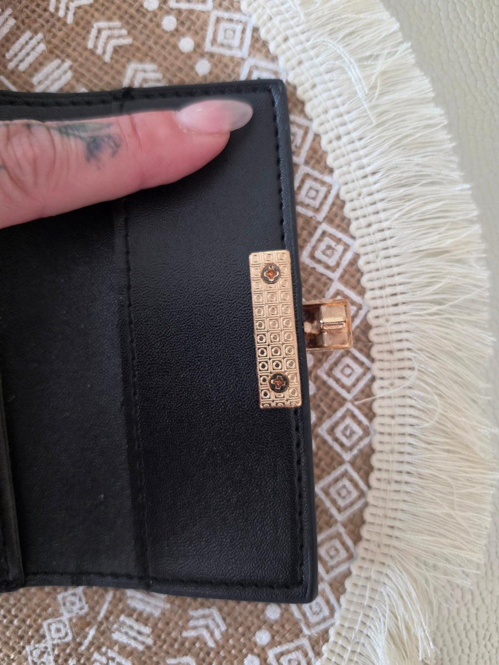 Gucci GG Supreme compact wallet — close-up gold padlock hardware detail