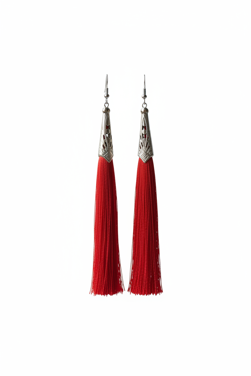 Red tassel earrings on white background