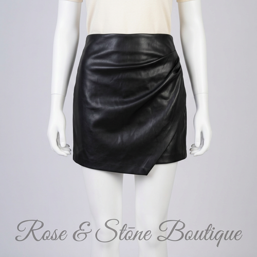 Illustrative mannequin styling of Dynamite black faux-leather ruched mini skirt