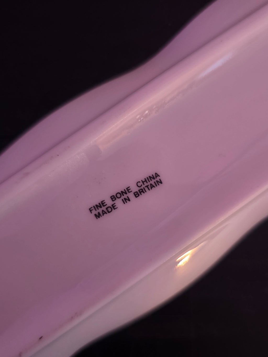 Text 'Fine Bone China Made in Britain' on a white surface.