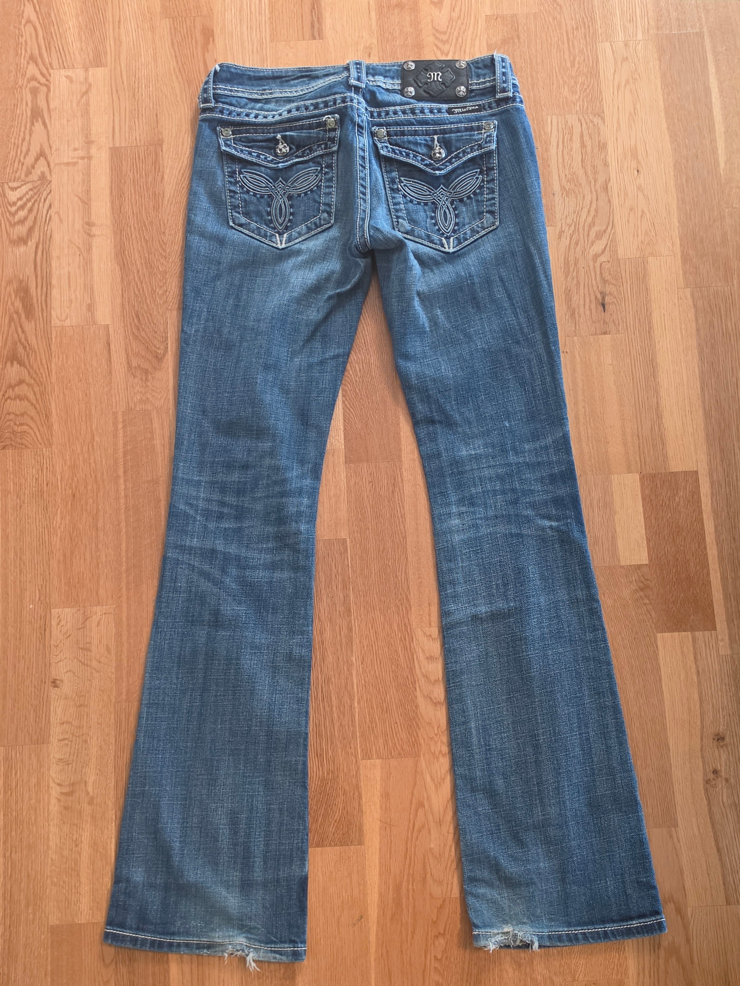 Miss Me jeans front waistband detail with ornate hardware and contrast stitching