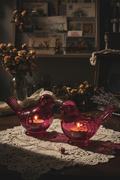 Two deep pink glass bird candle holders